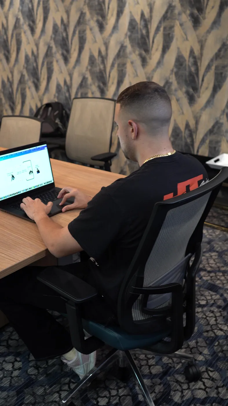 Optic Vault team member editing client campaigns at a workstation